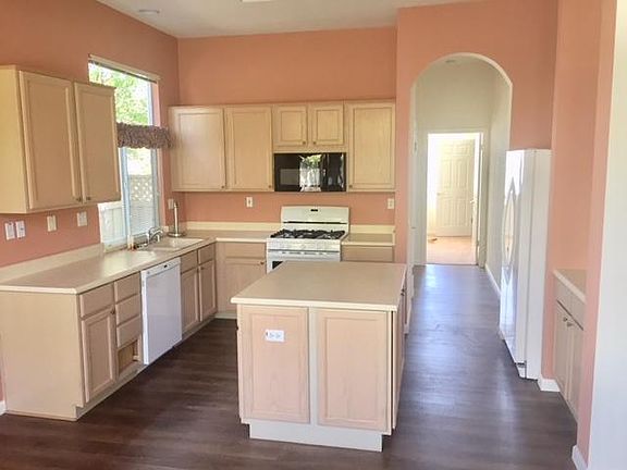 Cabinetry perfect, open to Living Room, back yard.  