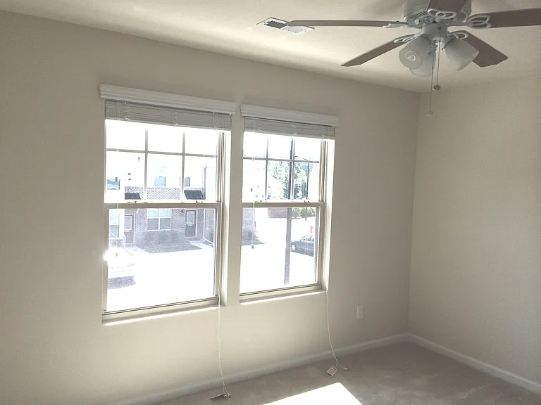 2nd Bedroom with double windows with screens | East facing - gets morning sunlight to refresh. BR features Ceiling fan with light| attached bath and closet
