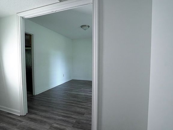 Spacious dining area with natural light and updated laminate flooring.