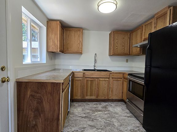 New kitchen with lots of cabinets and view of the backyard.