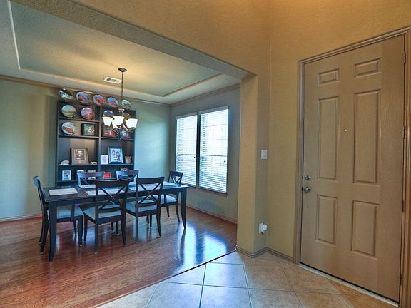 To the Right of the Entryway, You Will Find This Lovely Formal Dining Room Featuring Beautiful Wood Flooring, Crown Moulding and Custom Paint.