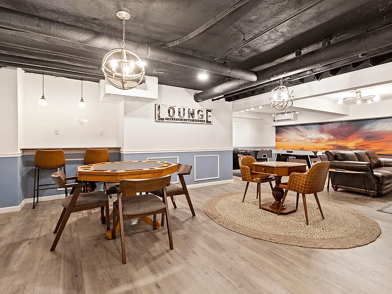 Experience relaxation and entertainment in this chic lounge space, perfect for unwinding.