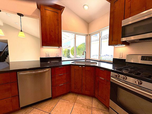 Kitchen showing windows by sink.