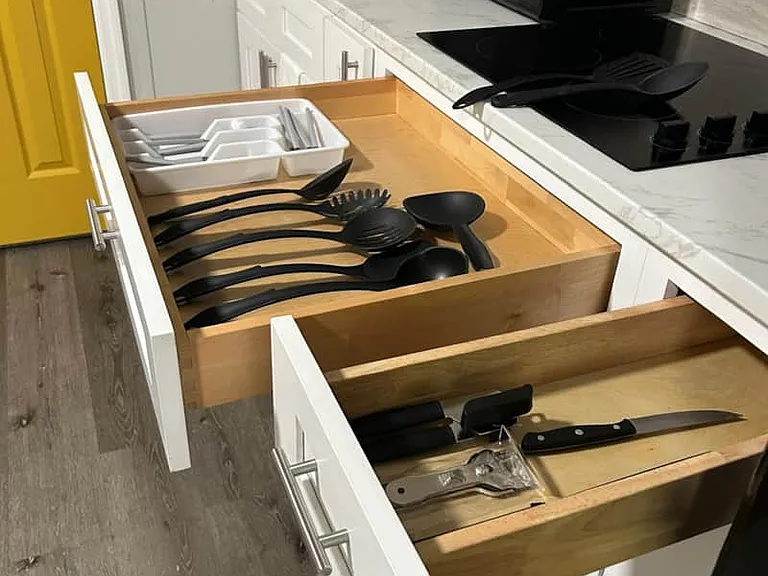 Kitchen stocked with cutlery, ladles, and big knives