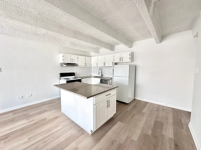 Modern kitchen with sleek countertops, stylish cabinetry, and spacious layout featuring an elegant island centerpiece. Modern kitchen with sleek countertops, stylish cabinetry, and spacious layout featuring an elegant island centerpiece.