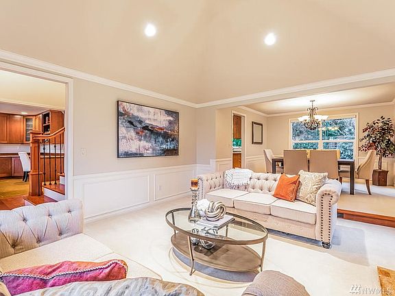 Another view of formal living room with entrance and stairs to second level on the left.