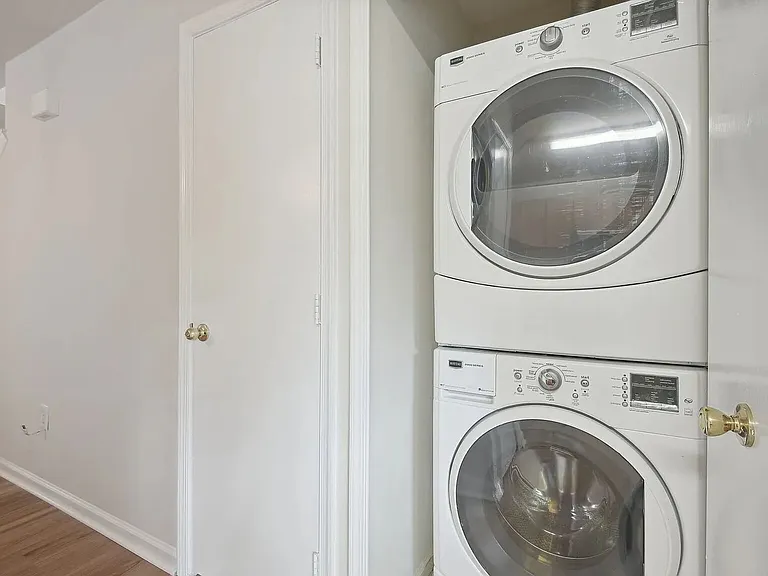 View of the laundry closet on the lower level and the coat closet door adjacent to it.