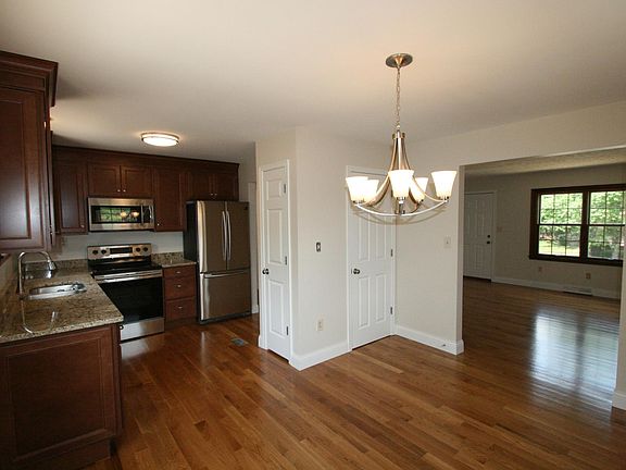Kitchen/dining area has two pantries, custom cabs granite co
