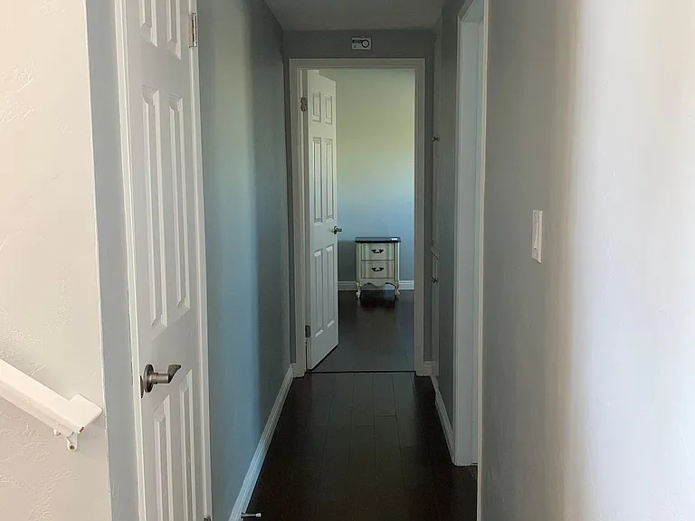 Hallway to bedroom #2; storage closet on the left, add'l storage closet down the hall on the right.