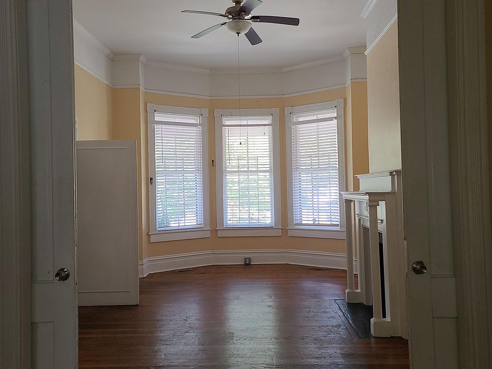 Front room could be a bedroom or living room. Original pocket doors lead to middle room.