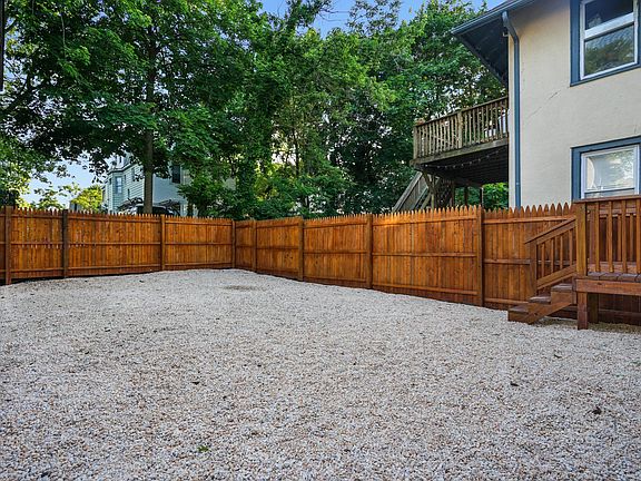 Access the sizable private pebble backyard with new fence and back stairs from the first floor unit.