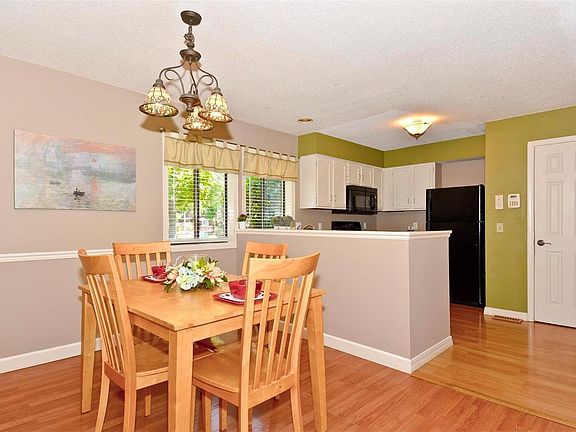 Separate Dining Room with Wood Veneer Flooring and Tiffany Style Lighting.