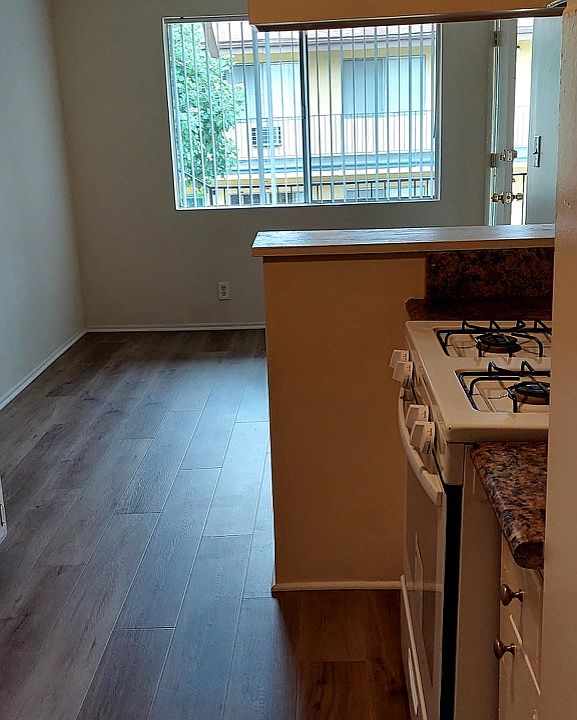 Kitchen to dining area view. Gas stove.
