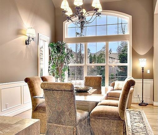 Formal dining with vaulted ceiling and Cherry floors