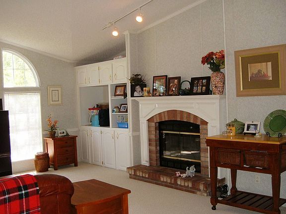 Family Room w/wood buring fireplace and built in entertainment center.