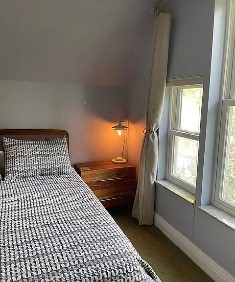 End table with two drawers and lamp.