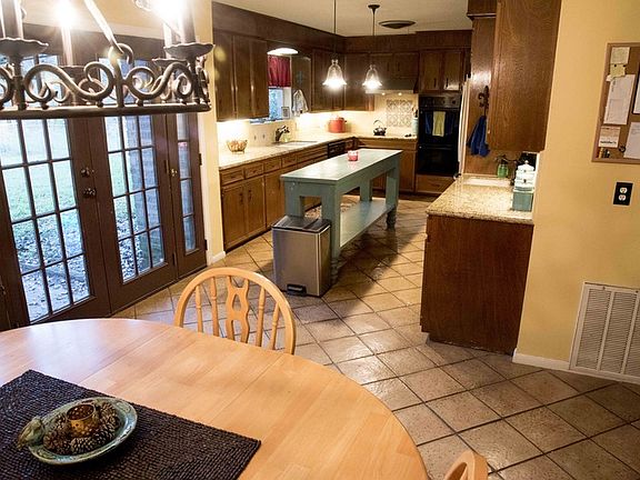 Kitchen : Doors exit to fenced backyard