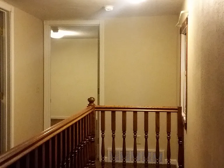 upper level hall leading to bedroom bath and sitting area