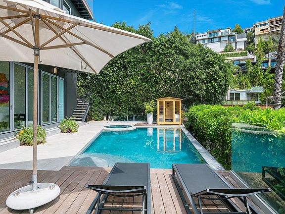 Outdoor area with pool, outdoor seating, indoor-outdoor fun room connecting the pool to the inside of the home