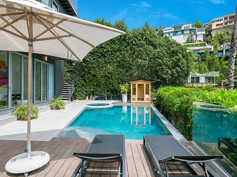 Outdoor area with pool, outdoor seating, indoor-outdoor fun room connecting the pool to the inside of the home
