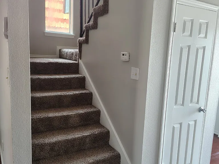 stairway going to both bedroom and 2 bathrooms