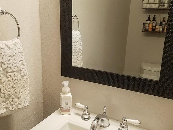Downstairs 1/2 bath, pedestal sink and toilet. Perfect little powder room.