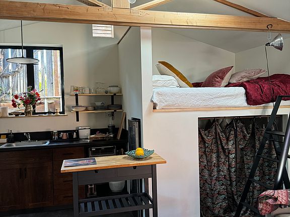 Kitchen with island and loft bed.
