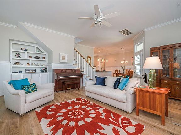 Great room with wide plank hardwood floors and built in cabinetry