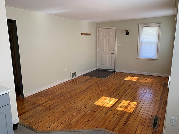Unfurnished Living Room with Natural Wood Floors