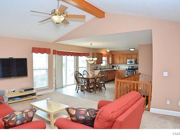 Living Room looking into Breakfast Room and Kitchen and stairs with gate to lower level.