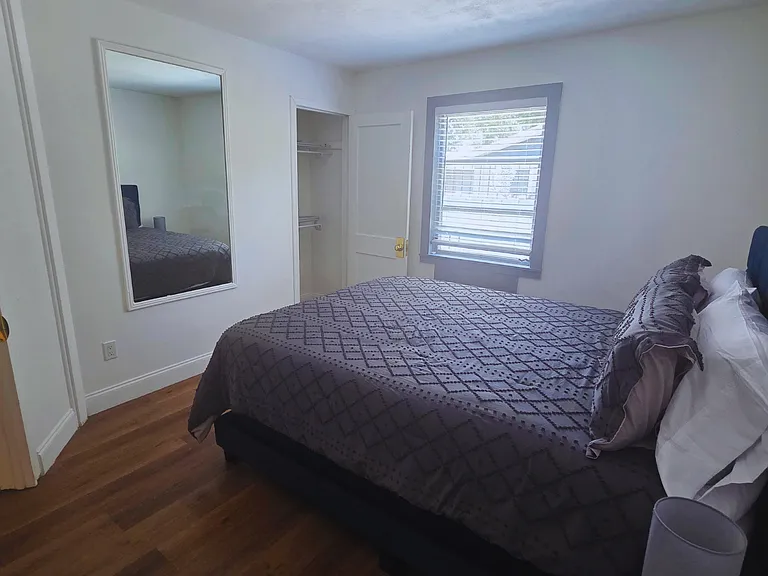 Relax in a bright, cozy bedroom with premium linens and a plush queen bed.