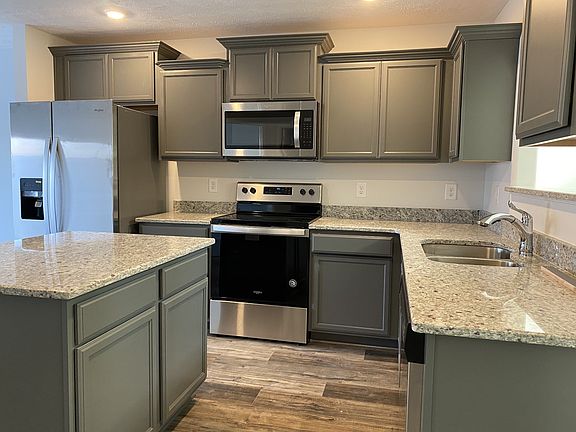 Kitchen has upgrade storm cabinets, island, granite, and stainless steel appliances. File Photo