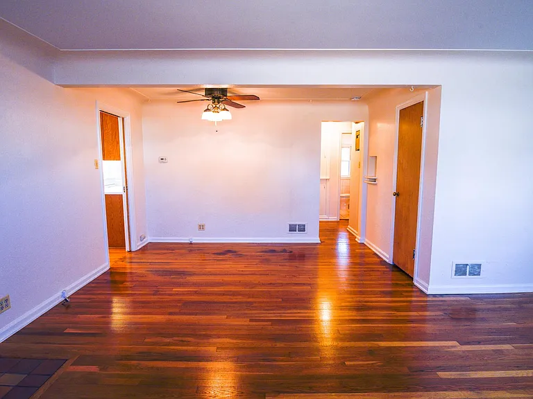 View from front window in living room. You can see kitchen, and hallway to three bed rooms and 1 bathroom. Coat closet seen here. Additional linen closet and storage cupboards in hallway.