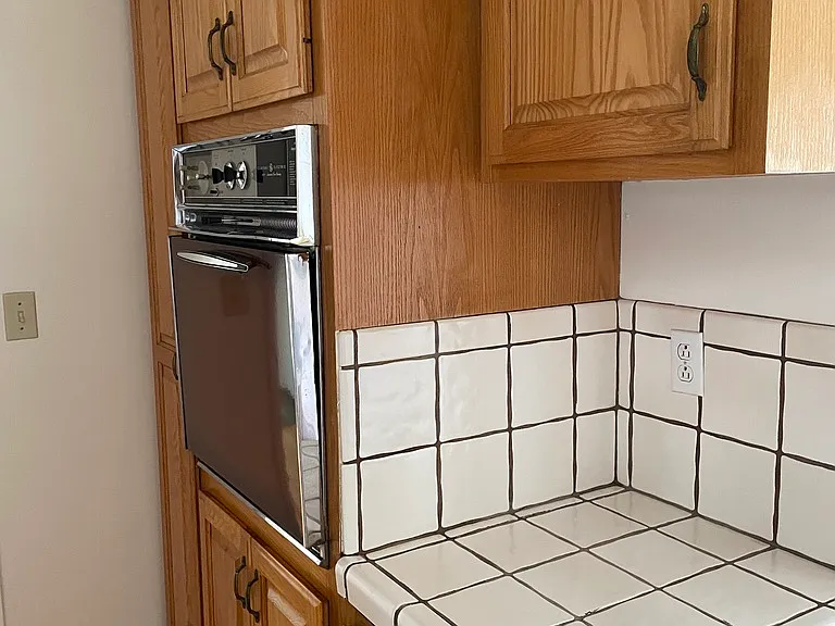 kitchen built-in oven, cabinets, counter
