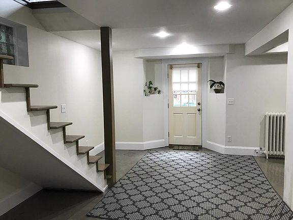 Another angle of lower level living area which has a door to an outside area. This picture was taken before the cable system was installed on the stair system