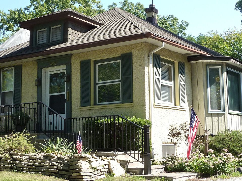 Front of house with new bluestone and wrought iron patio