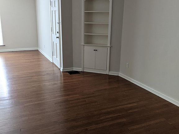 This photo is taken from one end of the dining room with a built in cabinet.