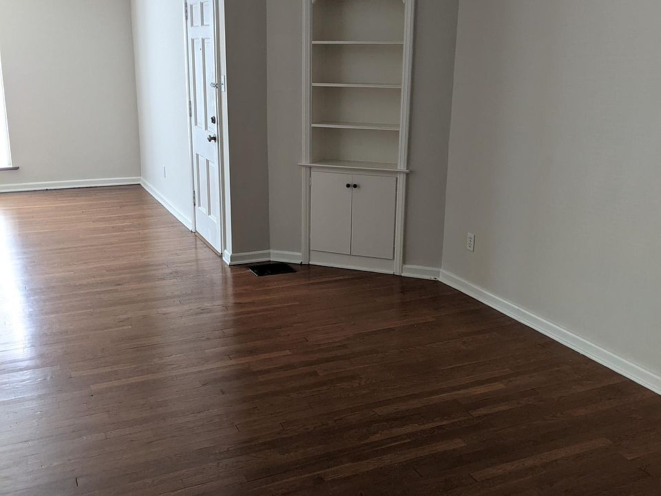 This photo is taken from one end of the dining room with a built in cabinet.