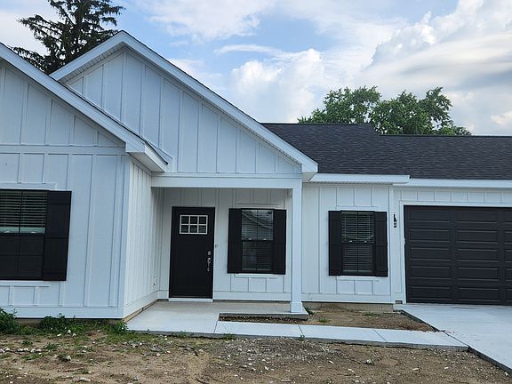 Front door with low threshold. Large windows bring in lots of natural light, and a full two-car garage.