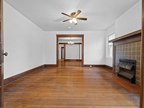View from sun room into living room - original fireplace and french doors!