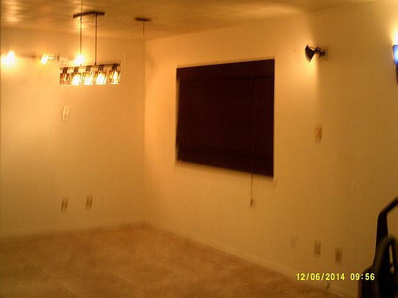 dining area with window looking out to back fenced  yard