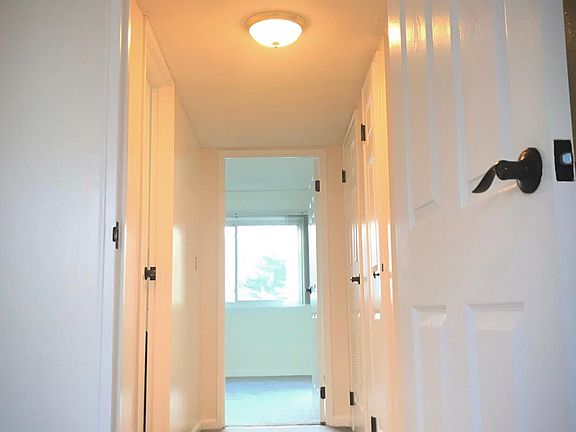 Hallway from 2nd bedroom to master suite. Updated light fixtures throughout