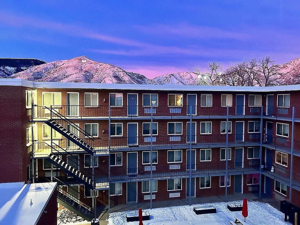 Experience luxury living with stunning mountain views from your serene apartment courtyard.