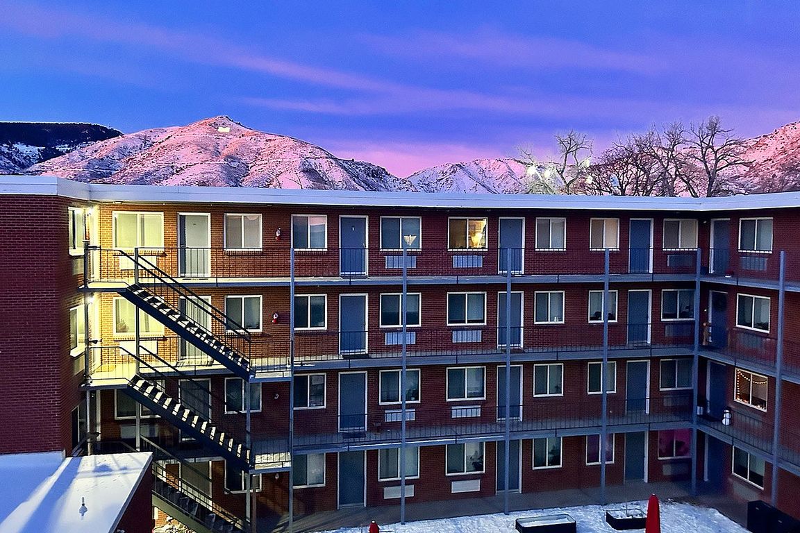 Experience luxury living with stunning mountain views from your serene apartment courtyard.