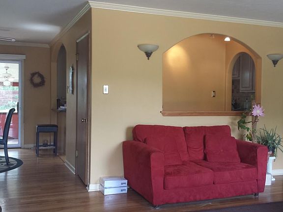 The living room flows into the dining room and hall that leads to three bedrooms and two baths.