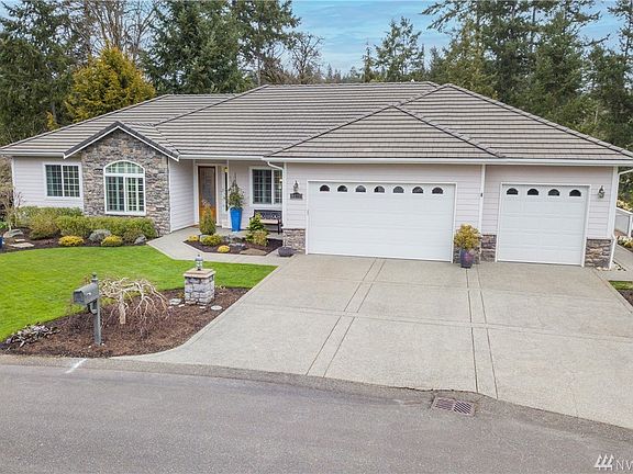 Front view showing gardens & beautifully landscaped grounds.