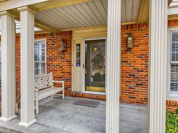 Charming covered front porch greets guests