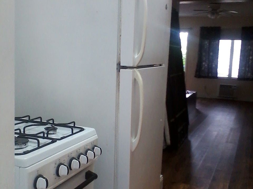 Kitchen to front door view. This floor is all luxury laminate as all on 2md floor. First floor units are ceramic tile due to exposure to climate & beach proximity.