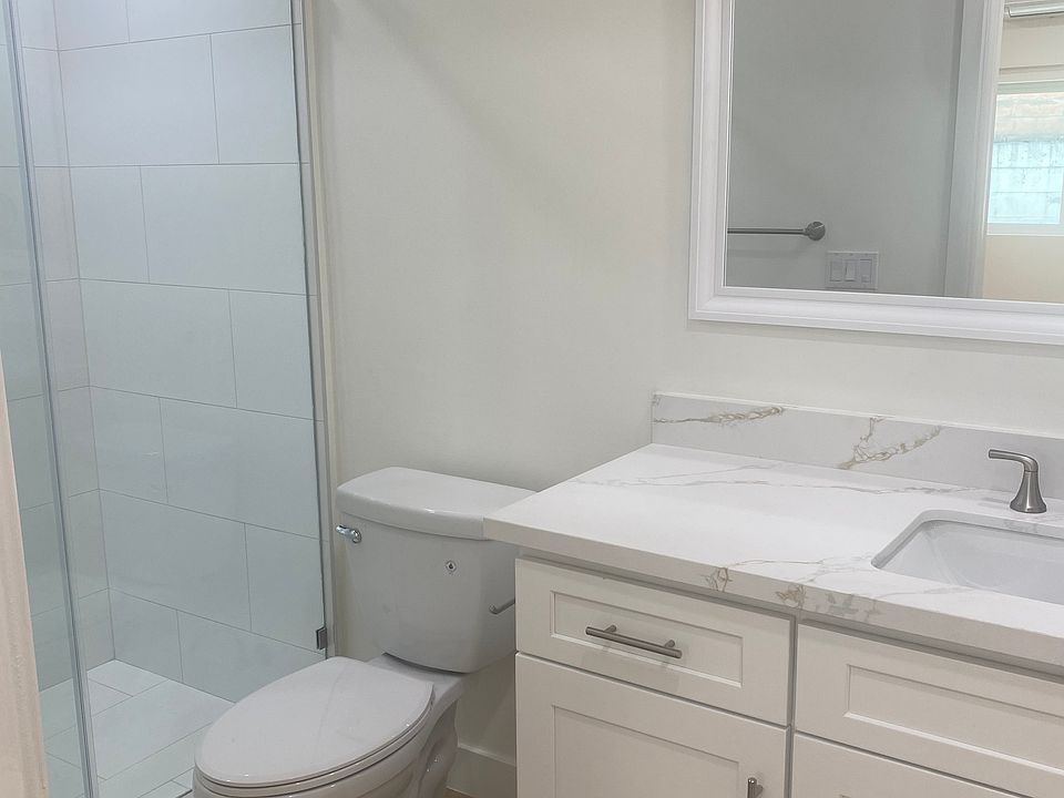 Spacious brand new bathroom with extra counter space and storage