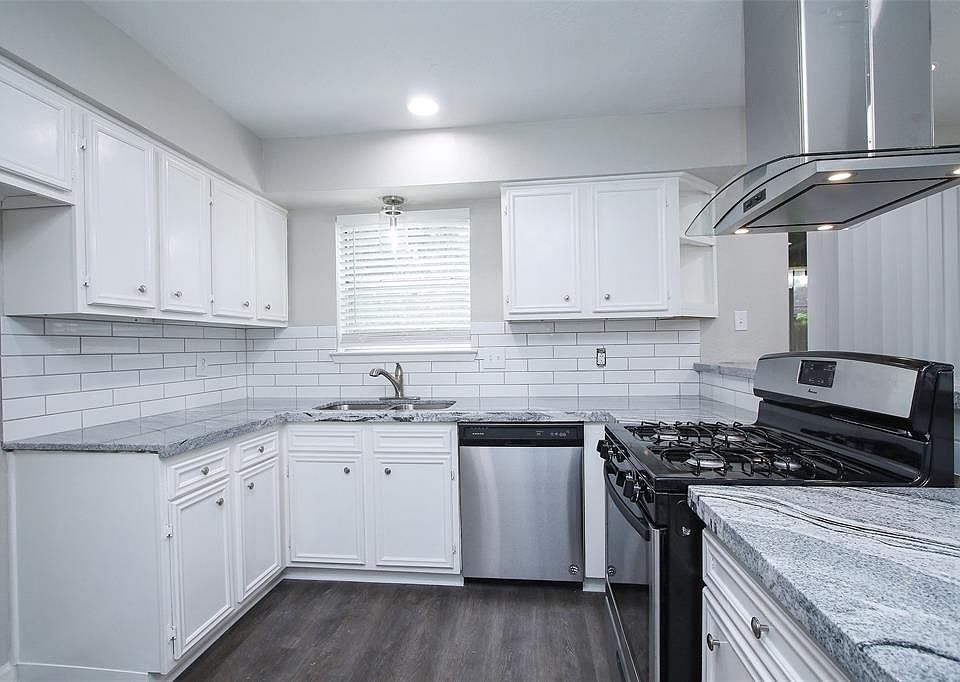 Look at this beautifully updated kitchen! The gorgeous counters are perfectly accented by the stainless steel appliances and range hood.